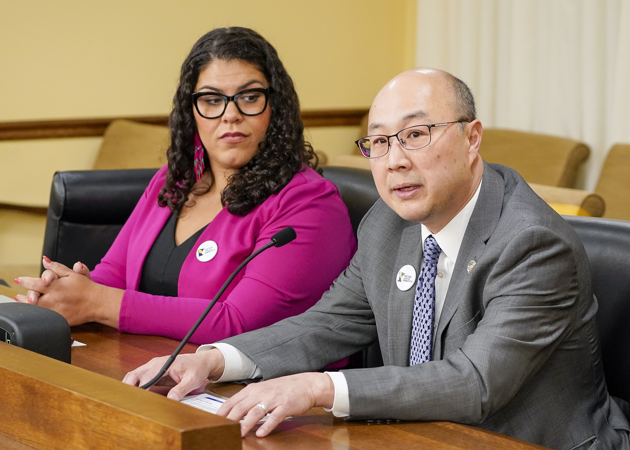 Ramsey County Attorney John Choi testifies before the House rules committee April 28 in support of a bill sponsored by Rep. Athena Hollins, left, that would propose a pretrial release, no cash bail constitutional amendment. (Photo by Andrew VonBank)